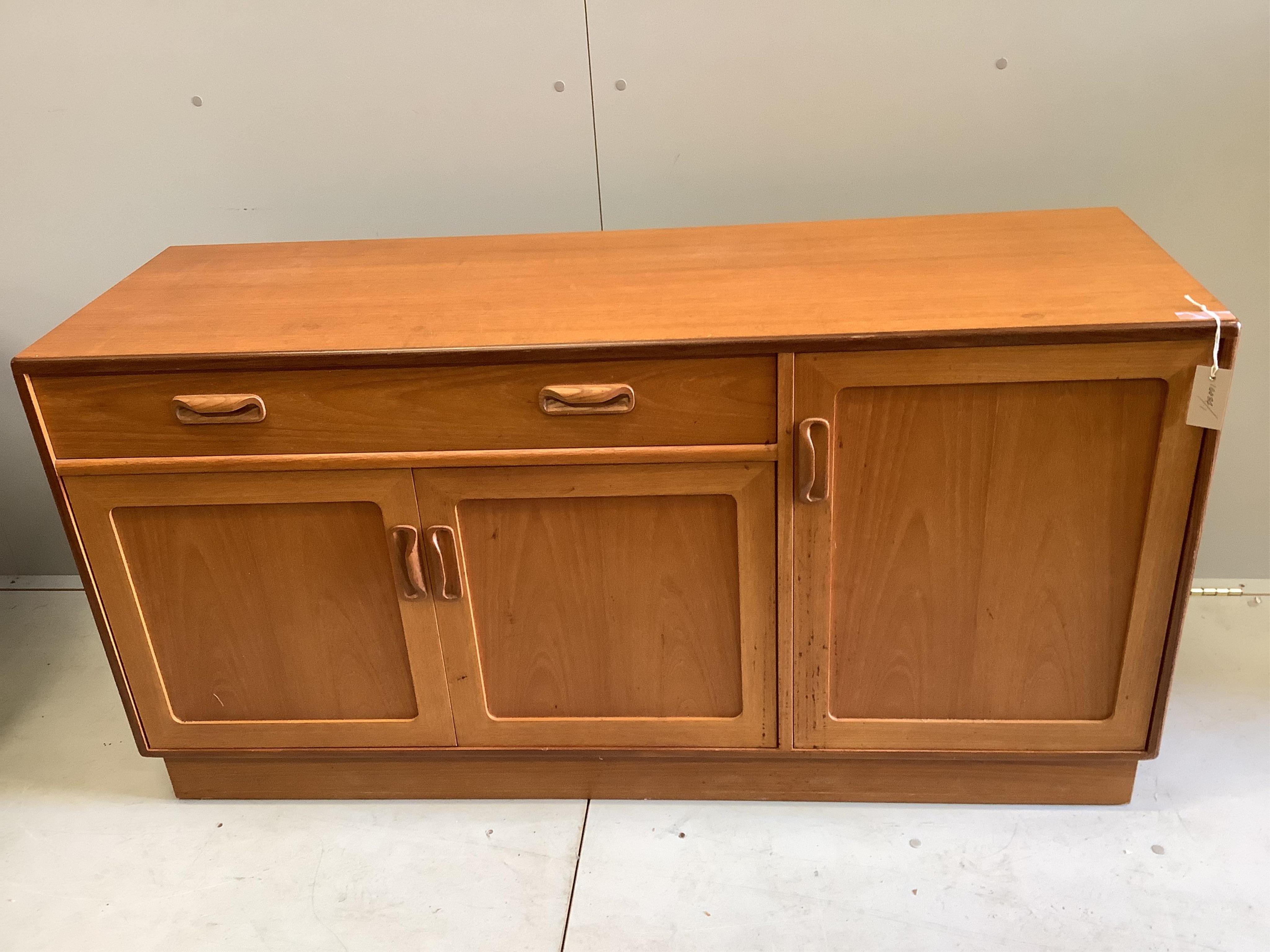 A mid century G Plan teak circular extending dining table, diameter 122cm, four chairs and sideboard, width 138cm, depth 44cm, height 72cm and a nest of tables. Condition - fair